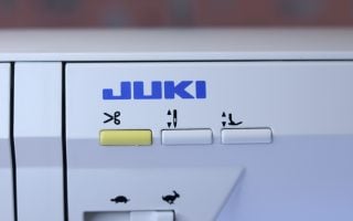 The thread trimmer button on the Juki NX7 sewing machine